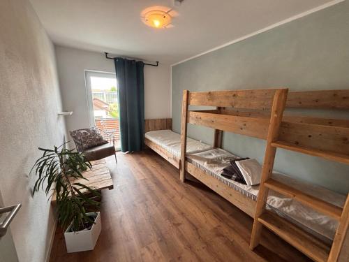 a room with a bunk bed and a couch at Fewo Dandelion in Haag