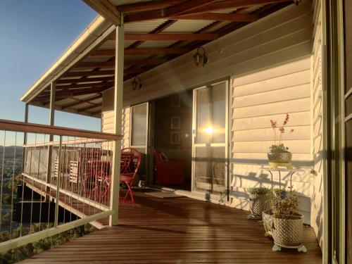 a porch of a house with a wooden deck at Eagle's Nest in Stanthorpe