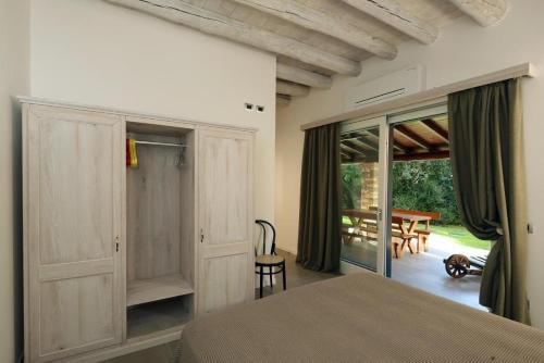 a bedroom with a bed and a sliding glass door at Al Segnavento Roccafredda in Toscolano Maderno