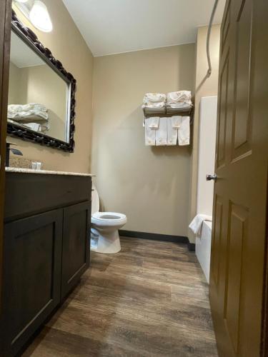 a bathroom with a toilet and a sink and a mirror at Wagon Wheel Yellowstone in West Yellowstone