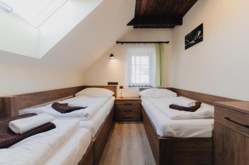 a room with three beds and a window at Villa Jizbička in Náchod