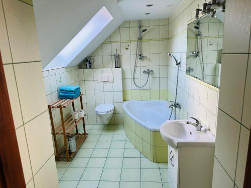 a bathroom with a sink and a shower and a toilet at Gasthaus Radków in Radków