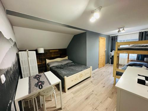a room with two bunk beds and a table at Gasthaus Radków in Radków