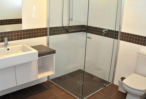 a bathroom with a shower and a sink and a toilet at Triggerplant 3 in Dinner Plain
