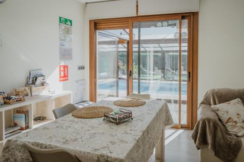 a dining room with a table and a glass door at La Costana De Barbadillo in Barbadillo del Mercado