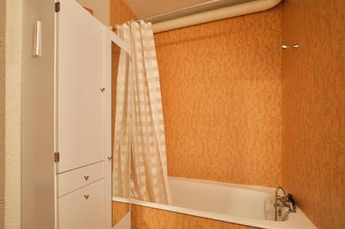 a bathroom with a bath tub and a mirror at Cosy and nice view on mountains in Villard-de-Lans