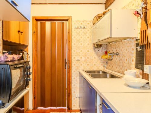 a small kitchen with a sink and a microwave at Apartment Chalet Altavista by Interhome in Ziano di Fiemme