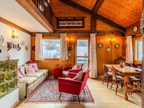 a living room with a couch and a table at Apartment Chalet Altavista by Interhome in Ziano di Fiemme