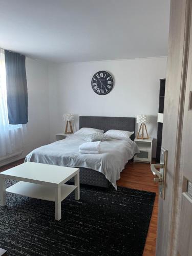 a bedroom with a bed and a clock on the wall at Casa Gla in Râşnov