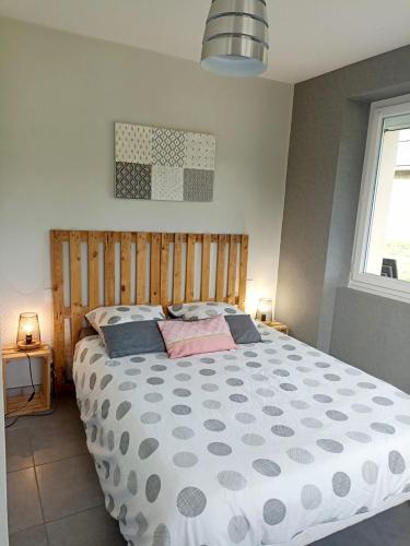 a bedroom with a large bed and a window at La Clematite d'Olt in Saint-Côme-dʼOlt