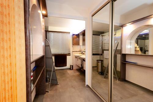 a bathroom with a sink and a mirror at Maison avec Piscine, Spa et Jacuzzi in Saint-Jean-dʼArvey