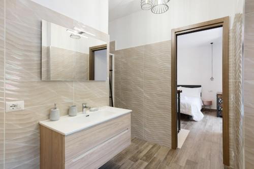 a bathroom with a sink and a mirror at La Casetta In Canada' in Agerola