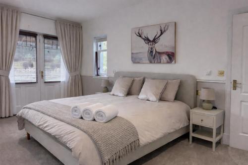 a bedroom with a bed with two towels on it at Daviot Lodge in Inverness