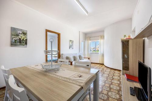 a living room with a table and a tv at Villas Brites nº4 in Burgau