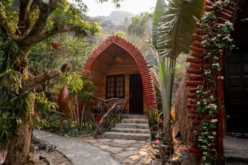 a house with an archway in front of a yard at THE GOAT BOUTIQUE RESORT in Ninh Binh