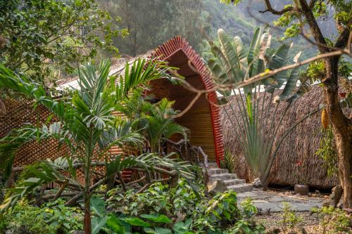 a garden with a house with a bunch of plants at THE GOAT BOUTIQUE RESORT in Ninh Binh