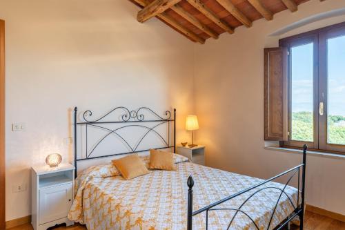 a bedroom with a bed and a window at Villa Adora Holiday Home in Serravalle Pistoiese
