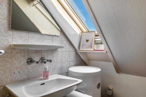 a small bathroom with a toilet and a sink at Storchennest in Ludwigsburg