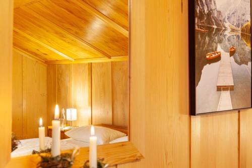 a room with a bed and a mirror with candles at Ferienhaus Dünser in Bizau