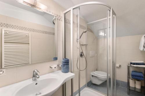a bathroom with a shower and a sink and a toilet at Loderhof Sand in Taufers in Sand in Taufers