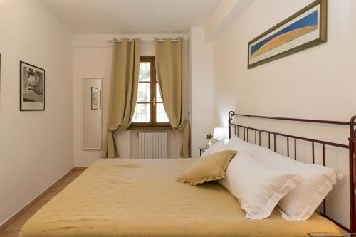 a bedroom with a large bed and a window at Podere Nuti - 1 La Regola in Cecina