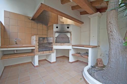 a kitchen with a pizza oven in a house at Casa Can Alou in Felanitx