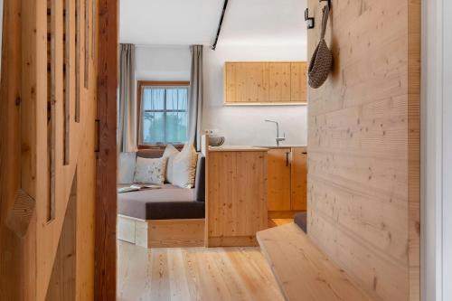 a small room with a bed and a kitchen at Chalet Stieber in Feldthurns