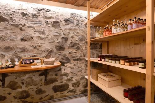 a room with wooden shelves and a stone wall at Chalet Stieber in Feldthurns
