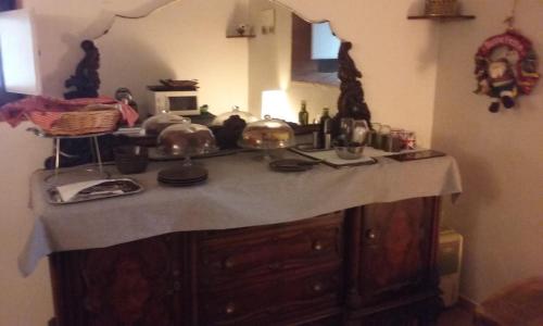 a kitchen with a counter with a table with dishes at Latera in Barberino di Mugello