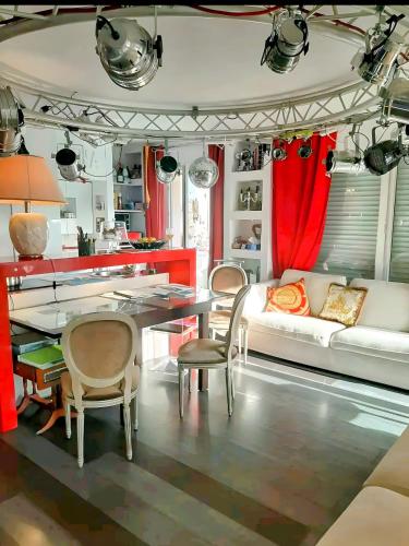 ein Wohnzimmer mit Tisch, Stühlen und Sofa in der Unterkunft Le Loft in Cannes