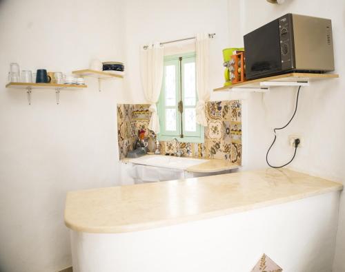 a kitchen with a counter top and a sink at Menzel LellaMina in Houmt Souk