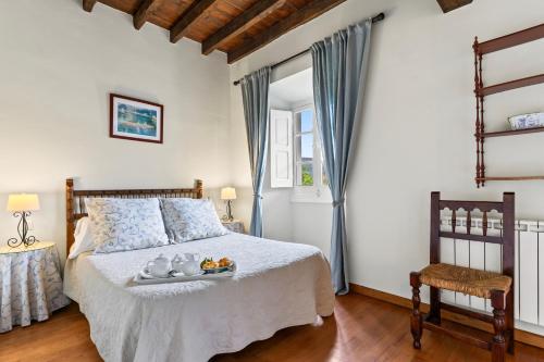 a bedroom with a bed with a tray of fruit on it at La Braña in Bustio