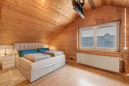 a bedroom with a bed in a wooden wall at Ferienwohnung Witt in Salem