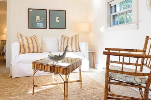 a living room with a white couch and a table at Downtown Historic Nantucket Cottage in Nantucket
