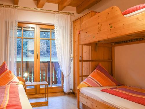 a bedroom with two bunk beds and a window at Stulzenhof in Hofstetten