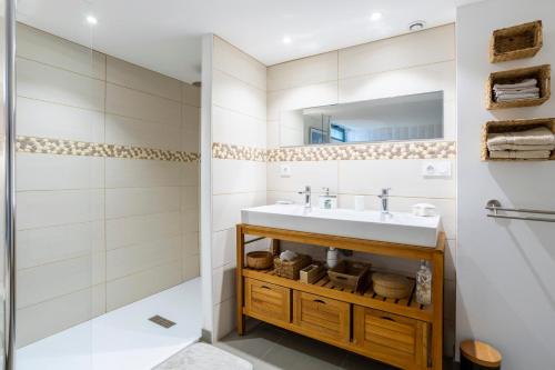 a bathroom with a sink and a shower at Grand Loft plein centre Concarneau in Concarneau