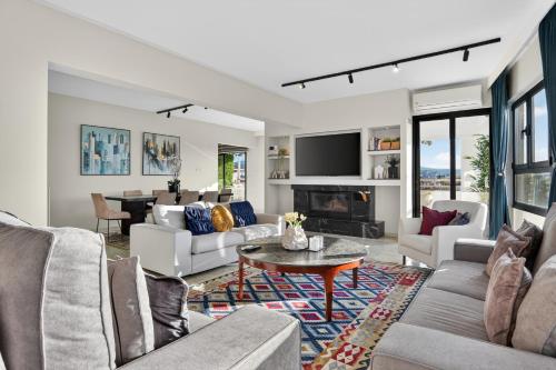 a living room with couches and a table at Amber View Penthouse 220sqm- overlooking downtown in Limassol