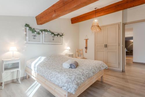 a bedroom with a large bed in a room at Maison Sainte-Maxime avec jardin in Le Plan