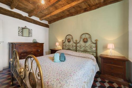a bedroom with a large bed and two chairs at Prima Del Cielo -Appartamento Monti in Esino Lario