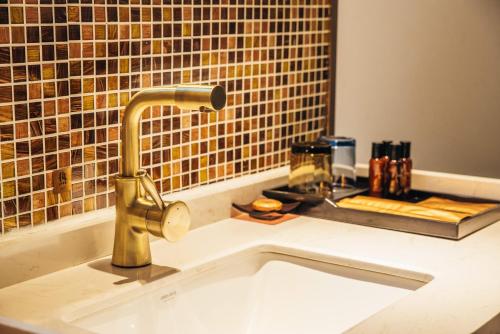 a kitchen sink with a faucet on a counter at James Joyce Hotel Zhuhai Hengqin Chimelong in Zhuhai