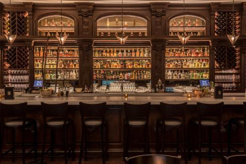 a bar at a restaurant with bar stools at Hollywood Historic Hotel in Los Angeles