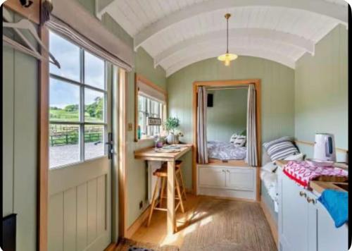 a bedroom with a bed and a desk and a mirror at Farm view hall in Harrogate