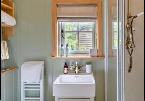 a bathroom with a sink and a window at Farm view hall in Harrogate