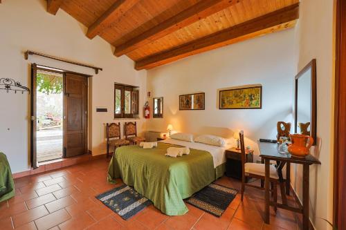 a bedroom with a bed and a table and a window at Ospitalità D'alunzio in San Marco dʼAlunzio