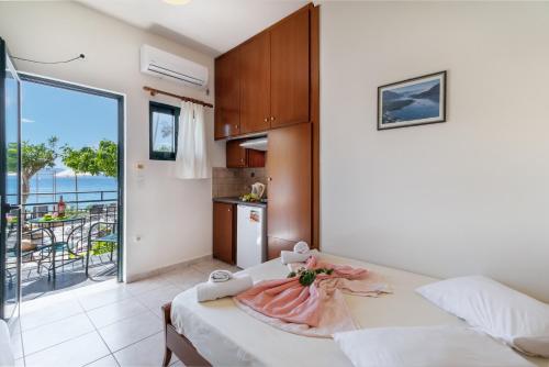 a bedroom with a bed and a view of the ocean at Nikiana Club - Studio 3 in Nikiana
