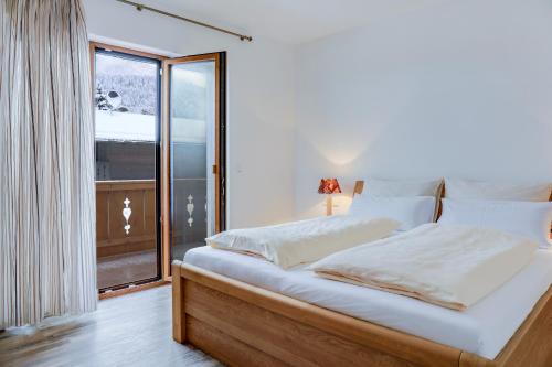 a bedroom with a large bed with a window at Ferienwohnung Schachen in Garmisch-Partenkirchen