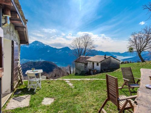a house on a hill with a table and chairs at Chalet Baita Santina by Interhome in Peglio