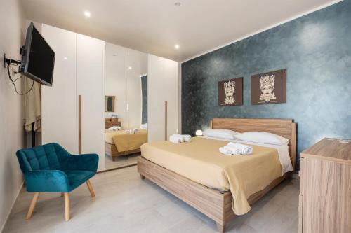 a bedroom with a bed and a tv and a chair at La Terrazza Di Porticello in Porticello