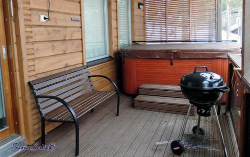 a porch with a grill and a bench in a room at PielisLinna in Kolinkylä