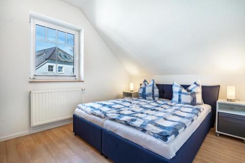 a bedroom with a large bed and a window at Ferienwohnung 2 in Groß Zicker